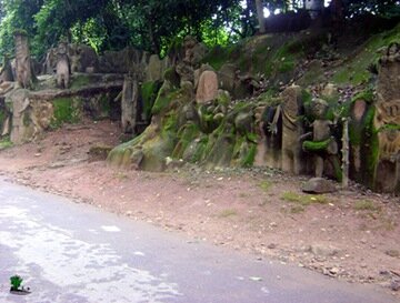 Sculpted images of various spirit gods, lining the road to the grove