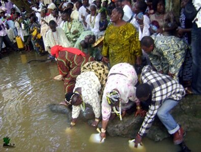 Worshippers collecting the river water after the sacrifice have been offered